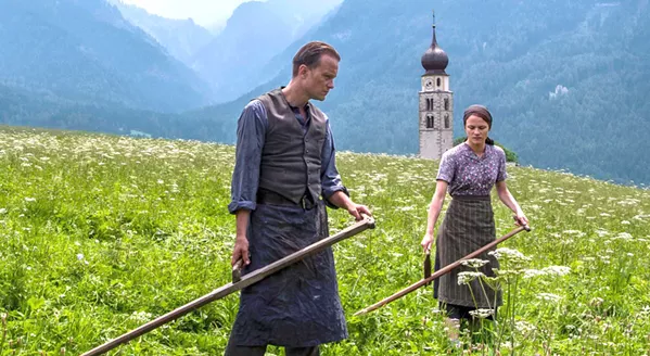 LAST CHANCE! August Diehl (left) stars as Austrian farmer Franz Jägerstätter, a conscientious objector who faces execution for refusing to fight for the Nazis in World War II, in auteur Terrance Malick's A Hidden Life, which leaves the Palm Theatre on Jan. 16. - PHOTO COURTESY OF STUDIO BABELSBERG