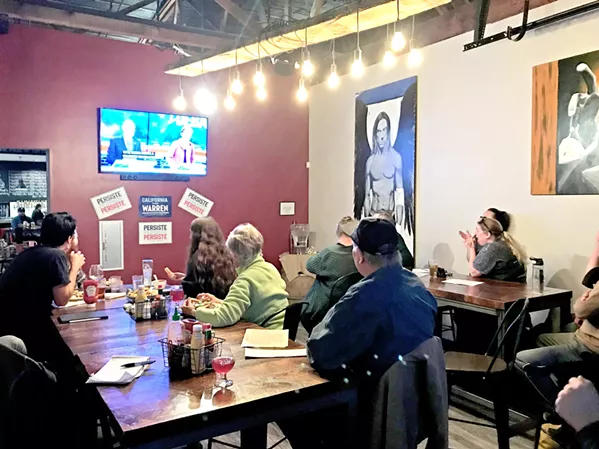 DEBATING Local Warren supporters convene at a debate watch party in Libertine Brewing Company's restaurant in downtown SLO on Feb. 19. - PHOTOS BY JAYSON MELLOM