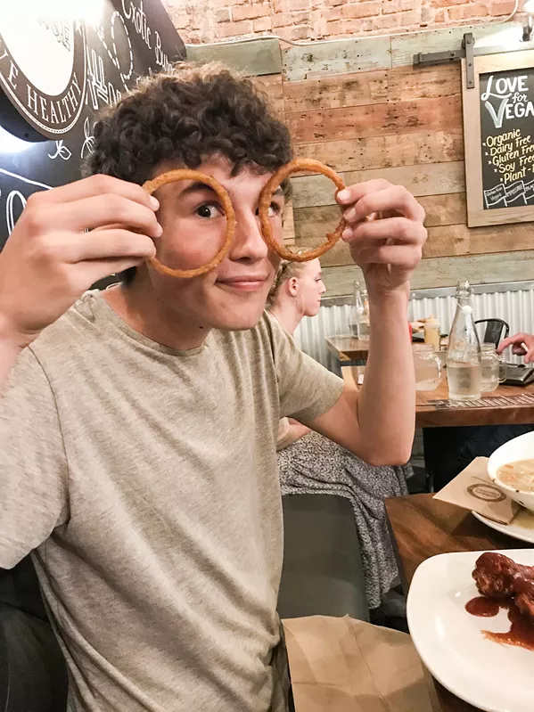 ONION RING SPECTACLES It’s okay to play with your food if your mother orders you to illustrate the gigantic size of the Burger Village onion rings. They go really well with the craft cherry coke. - PHOTO BY BETH GIUFFRE