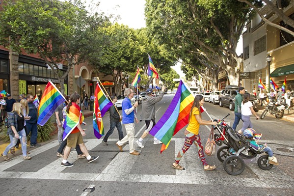 REVERSAL A group of demonstrators show their pride on Higuera Street in downtown SLO during a rally in 2017. On June 12 of this year, the U.S. Department of Health and Human Services removed nondiscrimination protections for transgender and nonbinary individuals seeking out health care and insurance coverage. - FILE PHOTO BY JAYSON MELLOM