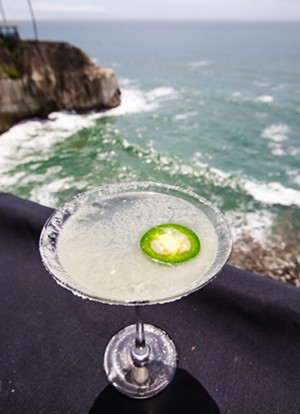 DRINK IT IN A jalapeño margarita enjoys one of the best views in the county, from the Ventana Grill deck, perched above the Pacific in Pismo Beach. - PHOTO BY JAYSON MELLOM