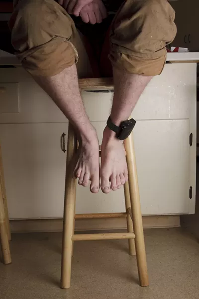 STRAPPED : Rather than serve a sentence in jail and risk losing his house and job, Jim opted for house arrest where he’s tethered by an electronic ankle bracelet. - PHOTO BY STEVE E. MILLER