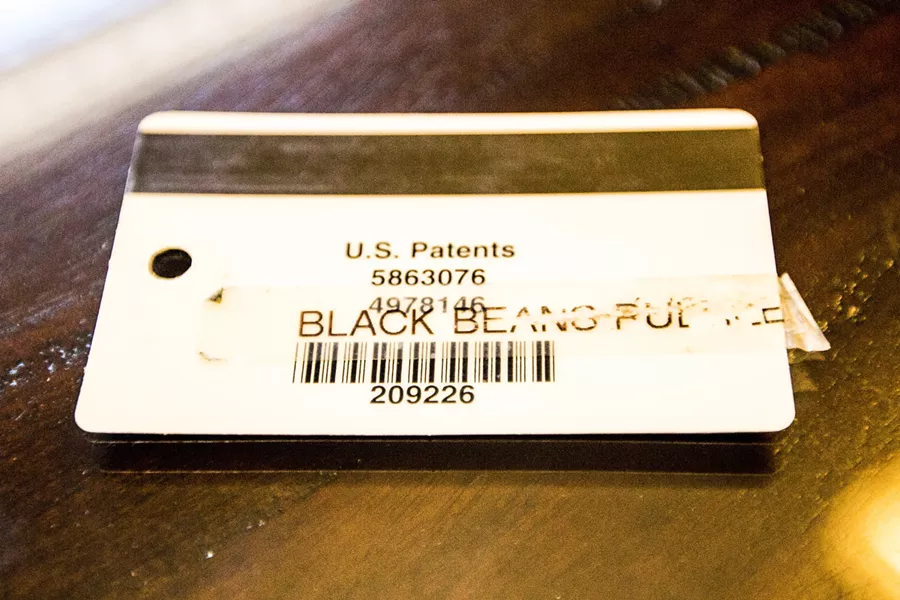 ‘BLACK BEANS RULE’: Janeka Samuels, who is black, alleges her supervisor gave her this nametag with the words “black beans rule.” - PHOTO BY HENRY BRUINGTON