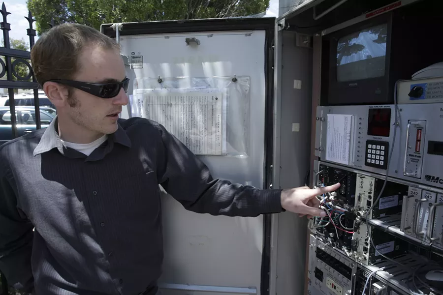 WHERE THE MAGIC HAPPENS : City traffic engineers, like Jake Hudson, used to have to drive out to an intersection utility box to fix traffic signals or the video system. Now, everything happens remotely. - PHOTOS BY STEVE E. MILLER