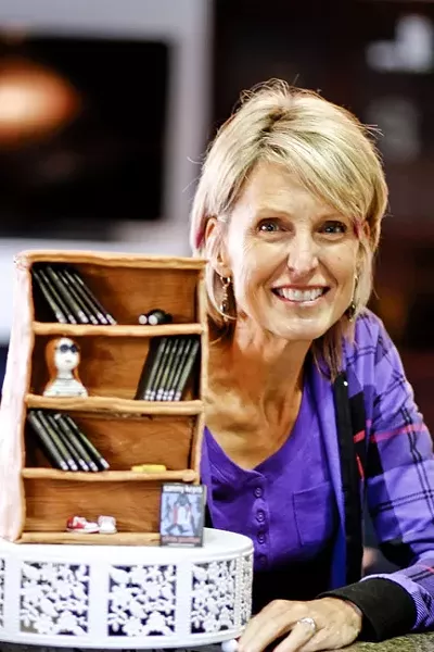 SWEET FINISH: Several friends celebrated Wendelin Van Draanen in the weeks before the release of her final Sammy Keyes book. Some of them collaborated on a cake made to resemble a bookshelf with individual chocolates designed to replicate each title in the series. - PHOTO BY WENDY THIES SELL
