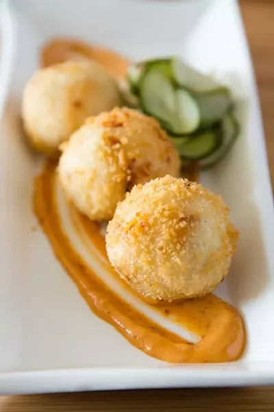 GREAT BALLS OF STEEL: KunFusion’s popular Balls of Steel are delightfully burning up pallets across the land with the mix of deep fried arepa dough stuffed with roasted habanero peppers, cheese, carrot, and spices. Sounds good? Try dipping one of these suckers in chef Lori Nunes’ chipotle aioli. It burns so good! - PHOTO BY TOM FALCONER