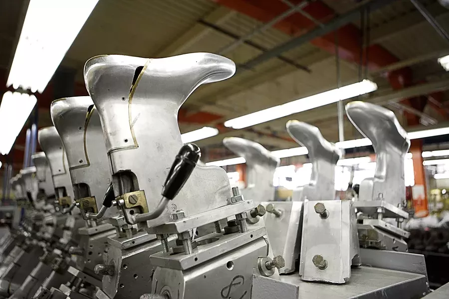 PUT YOUR BEST FOOT FORWARD : Silver shoe molds await another run of boots in the California Men’s Colony’s Prison Industry Authority-run shoe factory, one of three business operations staffed by inmates. - PHOTO BY STEVE E. MILLER