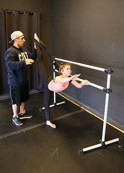 BEHIND THE VIRAL CLIPS: Teen YouTube dance star Sparkles Lund gets stretched out by her choreographer Marco Cruz at her home studio in Arroyo Grande. - PHOTO BY DYLAN HONEA-BAUMANN