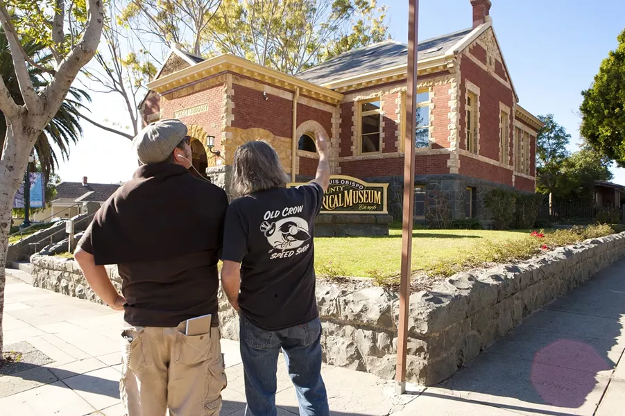 TOURISTS!: Glen Starkey and local artist David Settino Scott embarked on a podcast walking tour of SLO Town that begins in front of the Carnegie Library. - PHOTO BY STEVE E. MILLER