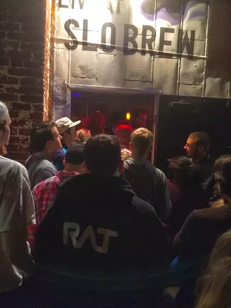 LET US IN!: Those who weren’t in line soon enough to buy one of the $10 tickets gathered in the alley to listen to Neil Young. - PHOTO BY GLEN STARKEY
