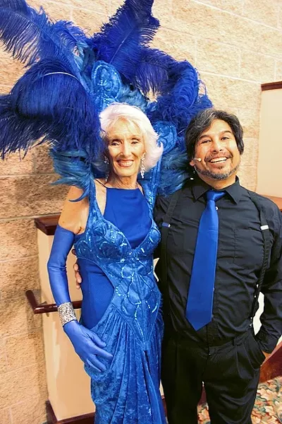 LAND OF DIXIE: Dixie Parker wears fully feathered and fabulous Central Coast Follie outfit with Jason Sumabat, director of the 13th annual Benefit for Parkinson’s Research “California Dreamin” show. - PHOTO BY REBECCA LUCAS