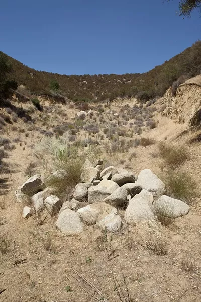 A STONE'S THROW: Danny Oster's property rests alongside the heavily traveled Highway 58, and only 200 feet from the backyard of his closest neighbors, the Finnegans, who believe they’re being intimidated because of their vocal opposition to the project. - PHOTO BY STEVE E. MILLER