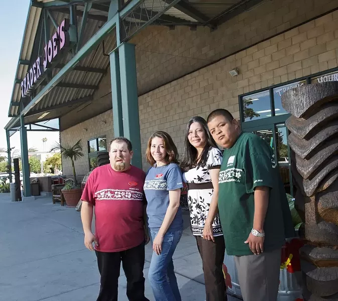 HARDWORKING MEN AND WOMEN : Aline Graham (center right), who directs PathPoint, and Mariá Méndez (center left), the job coordinator, provide top-notch employees for such area businesses as Trader Joe’s. - PHOTO BY MATT FOUNTAIN