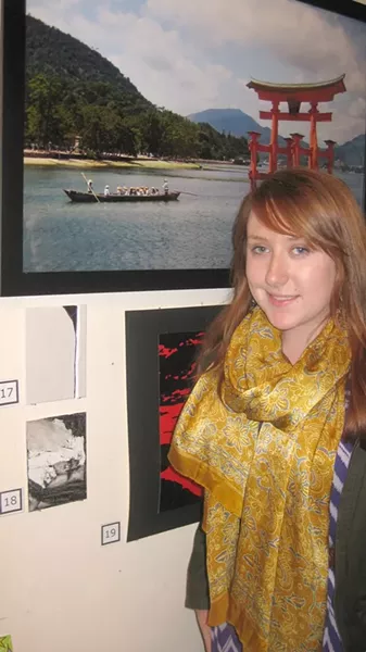 A CLAASSEN REDEMPTION : I didn’t mention the one Art After Dark exhibit that met my rigorous aesthetic demands. This is Hallie Travis with her painting (No. 18) and others by artists in the Cal Poly Architecture Department. - PHOTO BY NICK POWELL