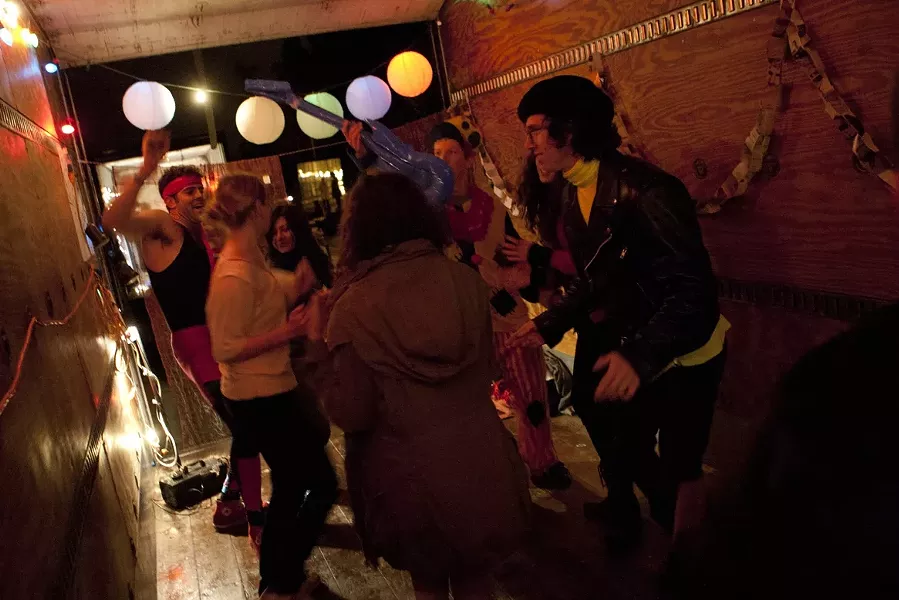 DANCE! : A small but enthusiastic throng of revelers gets its groove on in KCPR’s dance party truck. - PHOTO BY STEVE E. MILLER