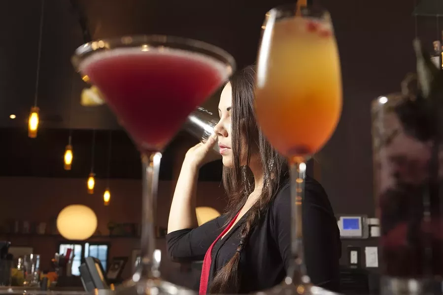 GETTING CRAFTY: Luna Red Assistant Bar Manager Rylie Houston brought back a little slice of the Big Apple when she returned to SLO County a little more than a year ago. Her savory creations bring a balance to the drink menu that complements the heavier style of Bar Manager Jason Nuss. - PHOTO BY STEVE E. MILLER
