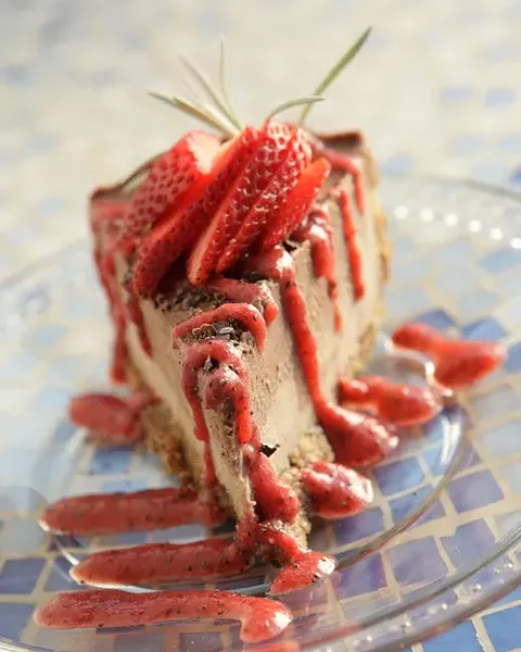 THIS IS RAW FOOD? : Forget any preconceived notions about raw food. Brandie Michelle is a live food artist and owner of the Smiling Dog Café in SLO who makes pies, like this strawberry “cheesecake”, as well as crackers, tacos, salads desserts and all kinds of gourmet meals, without an oven. - PHOTO BY STEVE E. MILLER