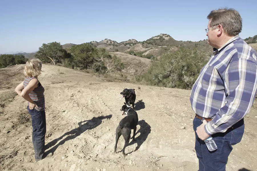 THE VIEW : The Allans look from a vantage at their ranch. The proposed oil operation would have oil tankers navigating roads like the one where they’re standing. - PHOTO BY STEVE E. MILLER