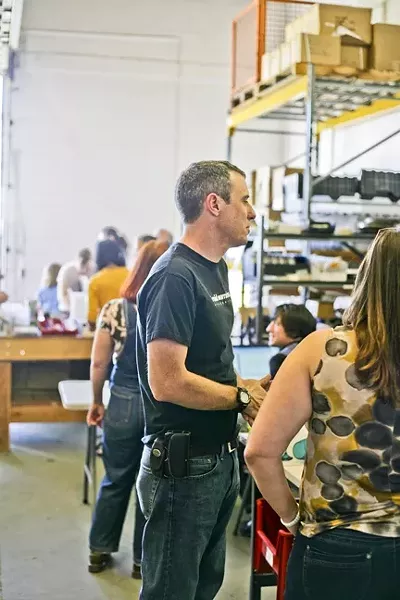 THE MAD SCIENTIST: Scott Miller (center) owns Argent Data Systems and opened up his workspace on Jan. 18 for people to come use his equipment to make stuff. - PHOTO BY GLEN STARKEY