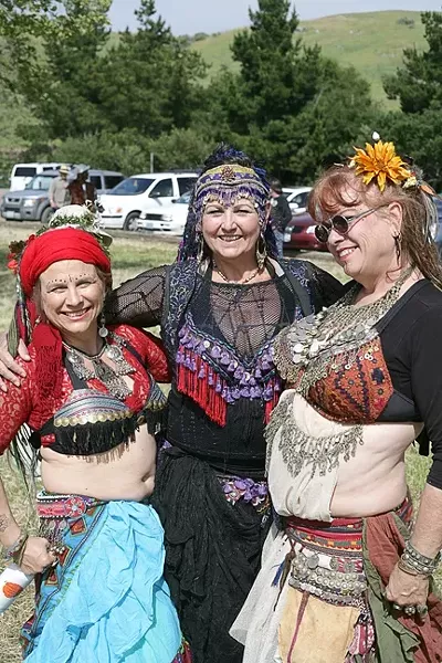THREE QUEENS : A trio of belly dancers struck a pose before performing for the crowd. - PHOTO BY GLEN STARKEY