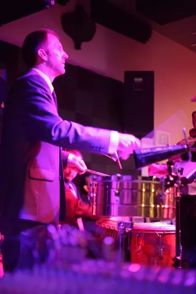 HE’S GOT THE BEAT : De La Bahia percussionist Mike Raynor and the rest of the band bring sultry Latin salsa music to Steynberg Gallery on June 18. - PHOTO BY GLEN STARKEY