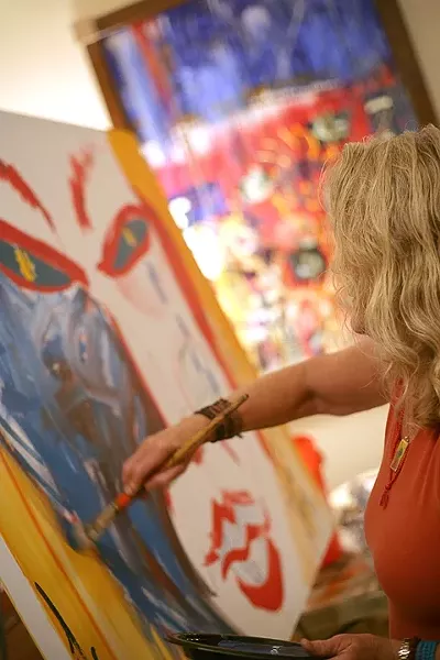 A LITTLE DAB WON’T DO YOU : Barbara Morningstar takes a few well-placed swipes at the communal painting. - PHOTO BY GLEN STARKEY