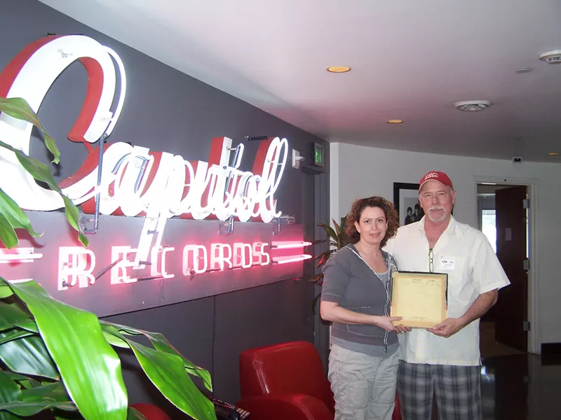 A DONE DEAL : Capitol/EMI executive Jane Ventom (left) presented Lance - Robison with a check in the Capitol Tower in Hollywood, money Robison used to record his album with the same producer Brian Wilson’s used since the ’80s. - PHOTO COURTESY OF LANCE ROBISON
