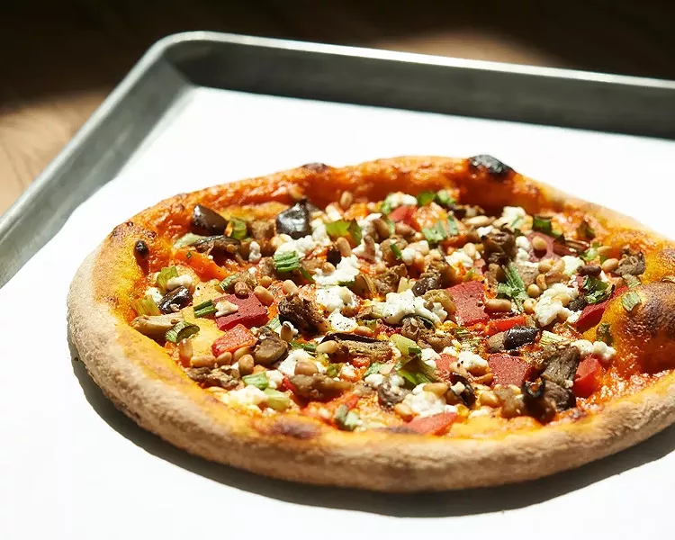 PIZZA OF THE MOMENT : Instead of pizza of the day, it’s of the moment (although all pizzas can be custom ordered). This one includes housemade roasted red pepper sauce, charred eggplant, goat cheese, toasted pine nuts, green onion, and roasted red pepper. - PHOTOS BY STEVE E. MILLER