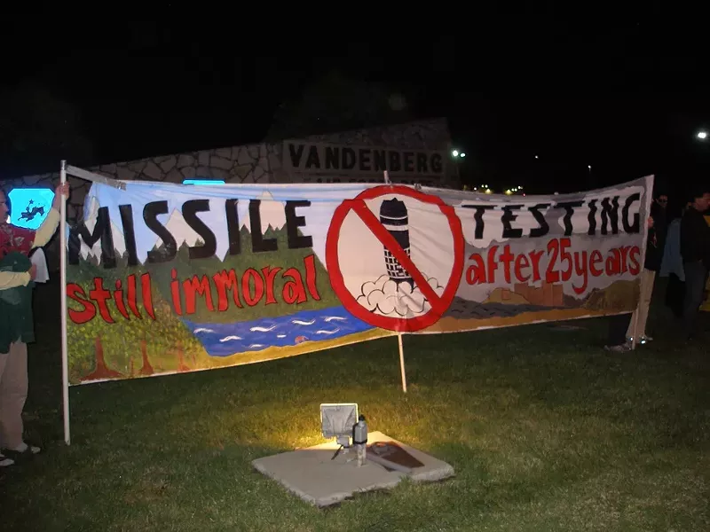 TAKING A STAND : Dennis Apel, McGregory Eddy, and Father Steve Kelly were arrested during a protest against missile testing such as the one pictured. - PHOTO BY NICHOLAS WALTER