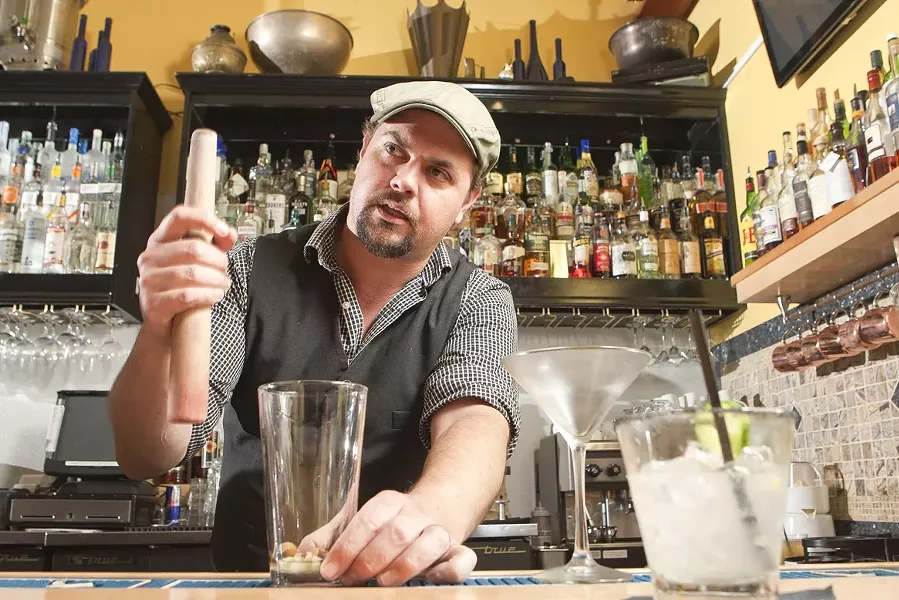 BARTENDER ROULETTE: Novo Bar Manager Matt Hanson encourages his staff to be creative and concoct their own exclusive cocktails in what’s known as the Bartender’s Roulette. - PHOTO BY STEVE E. MILLER