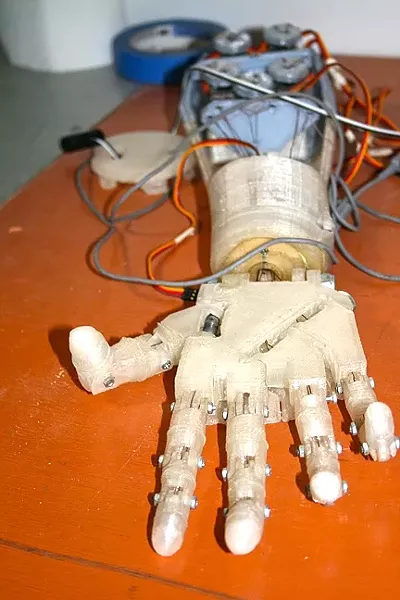 MR. ROBOTO : A robotic arm that can be controlled by Internet users hangs five at the SLO Makerspace. - PHOTO BY HAYLEY THOMAS