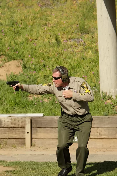 THE GOOD: Years of intensive training allow SLO County Sheriff’s Department Senior Range Master Steve Odom to fire his weapon while evading returned fire, exactly the kind of training needed by a citizen hoping to protect their home with a firearm. Most gun owners lack such training. - PHOTO BY STEVE E. MILLER
