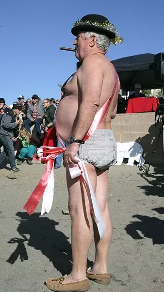 FATHER TIME OR BABY NEW YEAR? : The annual costume contest attracts plenty of wild participants, including this swaddled gentleman smoking a cigar and drinking a martini.