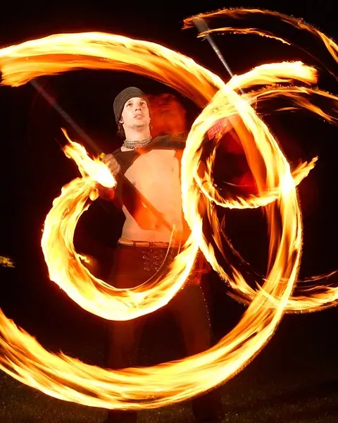 SPIN: Chris Williams initially began spinning poi in Thailand, but he now practices his skill at the park. - PHOTO BY STEVE E. MILLER