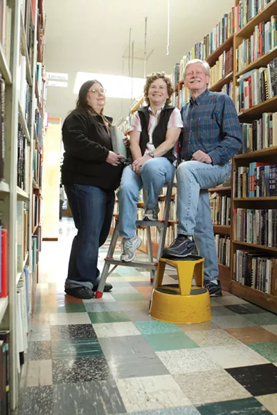 THREE OF A KIND : Susie Metzler, left, has been manager of Leon’s Book Shop for the last 18 years. Catherine and Rick Wiegers have owned the building and store since 1985. A new chapter of their lives will start on May 20, when Leon’s closes its doors. - STEVE E. MILLER