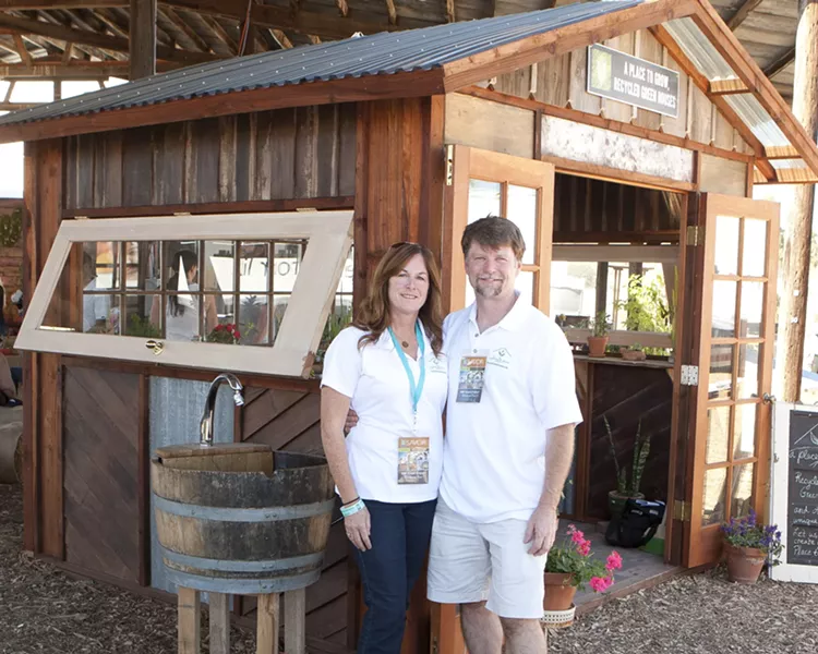 BEAUTIFUL RECYCLING: A Place to Grow creates custom-made greenhouses out of recycled materials that’ll make any yard look fantastic. Pictured here are the owners Dana and Sean O’Brien with a greenhouse showcased at the Sunset Savor the Central Coast event in Santa Margarita. - PHOTO BY STEVE E. MILLER