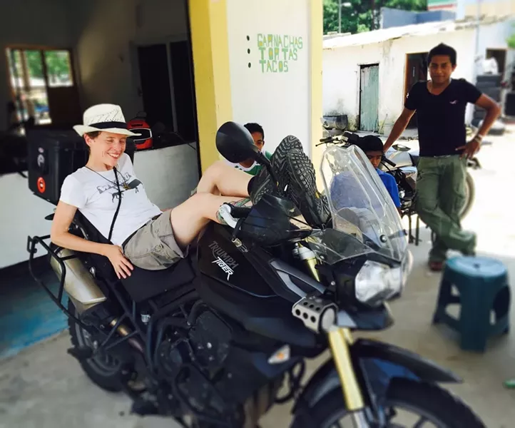 LAID BACK: Heather Johnson (left) rests on her Triumph Tiger in La Venta, Tabasco, Mexico after it broke down when she hit a pothole. - IMAGE COURTESY OF HEATHER JOHNSON