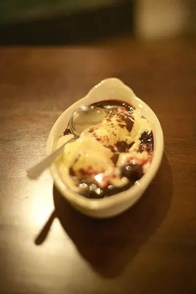 COURSE SIX : The evening concluded with ice cream topped with dark cherries and chocolate sauce. - PHOTO BY GLEN STARKEY