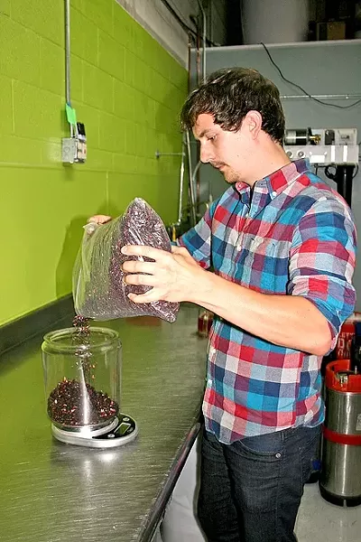 TO A TEA: Jake Pritzlaff of Whalebird Kombucha measures fragrant black tea from Secret Garden Organic Herb Shop in SLO. With just the right ingredients and a 30-day ferment, this tea will transform into tart, refreshing kombucha full of probiotic health benefits. - PHOTO BY HAYLEY THOMAS