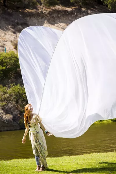 TAKE WING: This angel’s costume wasn’t the most elaborate, but it was the tallest! - PHOTO BY HENRY BRUINGTON
