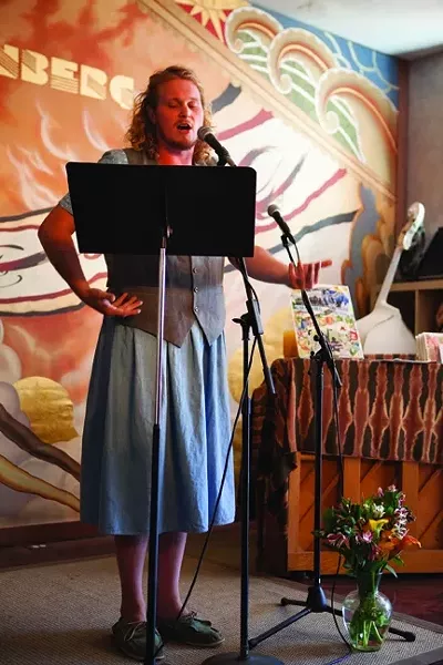 THAT’S A GUY IN A DRESS : Not only did Stuart Toll read some poetry, he also performed some music with the Allison Rice Trio. - PHOTO BY COLIN RIGLEY
