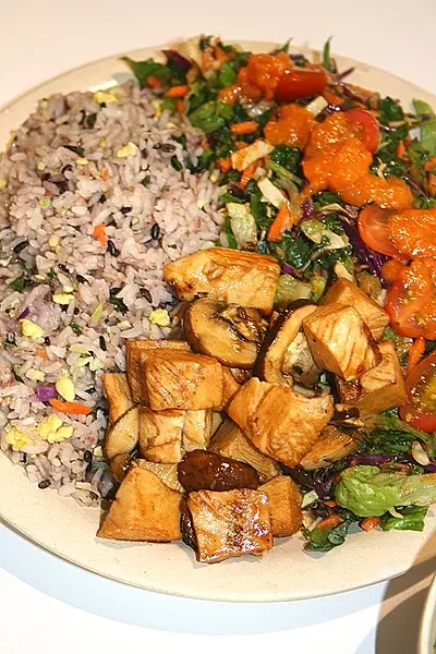 GREAT GREENERY: Salads at Oki Momo Asian Grill are served with a mix of satisfying veggies and creative, housemade dressings, including sweet carrot ginger, soy sesame, and Thai peanut. - PHOTO BY HAYLEY THOMAS