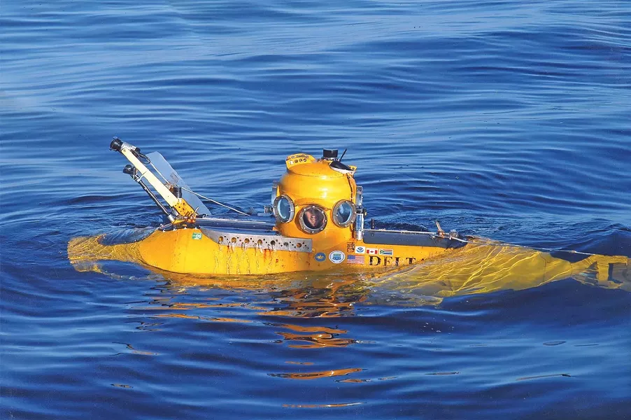 A YELLOW SUBMARINE : The Delta submarine researchers used to visit the wreck is so small, the operator’s chair straddles the passenger, who must lie prone and peer out of a separate porthole. - PHOTO BY ROBERT SCHWEMMER, NOAA