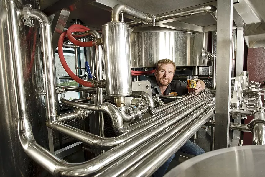 THEY ARE FOUR : Brewmaster and co-owner John Gordon is part of a four-man team brewing ale in an industrial part of San Luis Obispo. - PHOTO BY STEVE E. MILLER