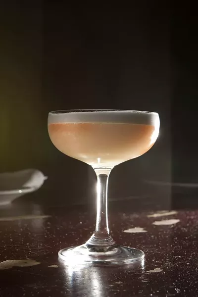 TWO DOLPHINS KISSING!: Everybody sees something different in the head of the frothy Abstract Art, but it’s consistently a floral blend of gin, bitters, egg whites, and lemon. Think of it as a tasty Lemon Julius. - PHOTO BY STEVE E. MILLER