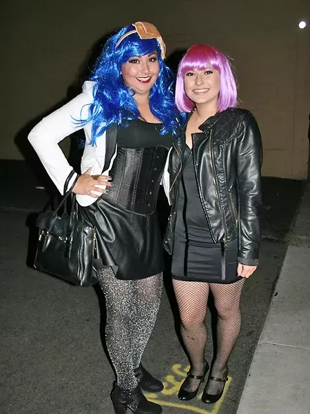 PARTY GOERS: From left, Theresa Michelle Triplett and Cameron Ruiz break out the neon wigs and gear up to dance 'The Time Warp.' - PHOTO BY HAYLEY THOMAS