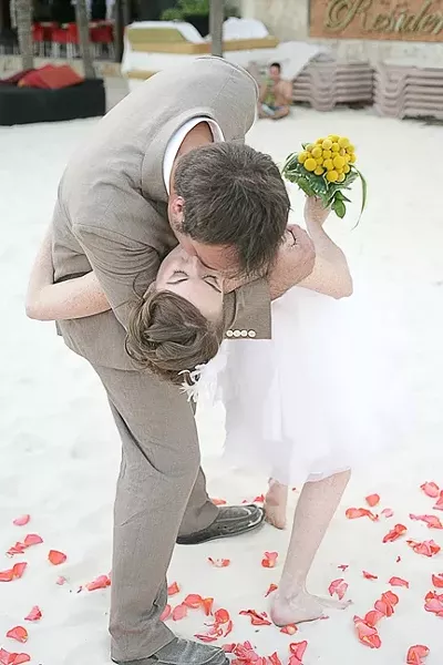 THE BIG KISS : After a paperwork-filled Mexican wedding ceremony, the newlyweds lay a big smacker on one another. - PHOTO BY GLEN STARKEY