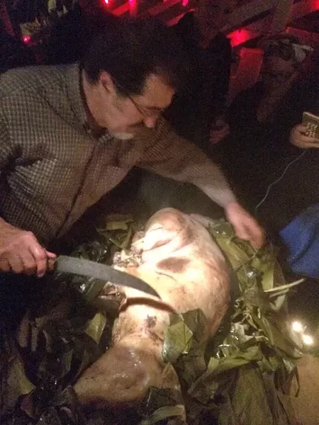 CARVING TIME: George Griffin, the driving force behind the pig roast, prepares to carve into the perfectly roasted pig. - PHOTO BY GEORGE GRIFFIN AND GLEN STARKEY