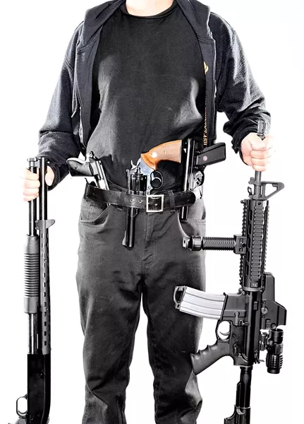 AND THE SCARY : Carbine (not his real name) has been fascinated by guns since childhood and frequently goes around armed even though he doesn’t have a CCW (concealed carry weapon) permit. In his early teens, he made a silencer for a handgun and used it to kill neighborhood cats, something he deeply regrets now. - PHOTO BY STEVE E. MILLER