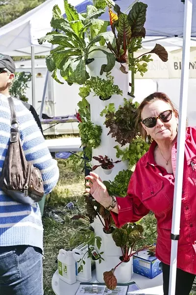 TOWER FOR POWER: Laura Austin extols the joys of healthy eating and the genius of the Tower Garden. - PHOTO BY GLEN STARKEY